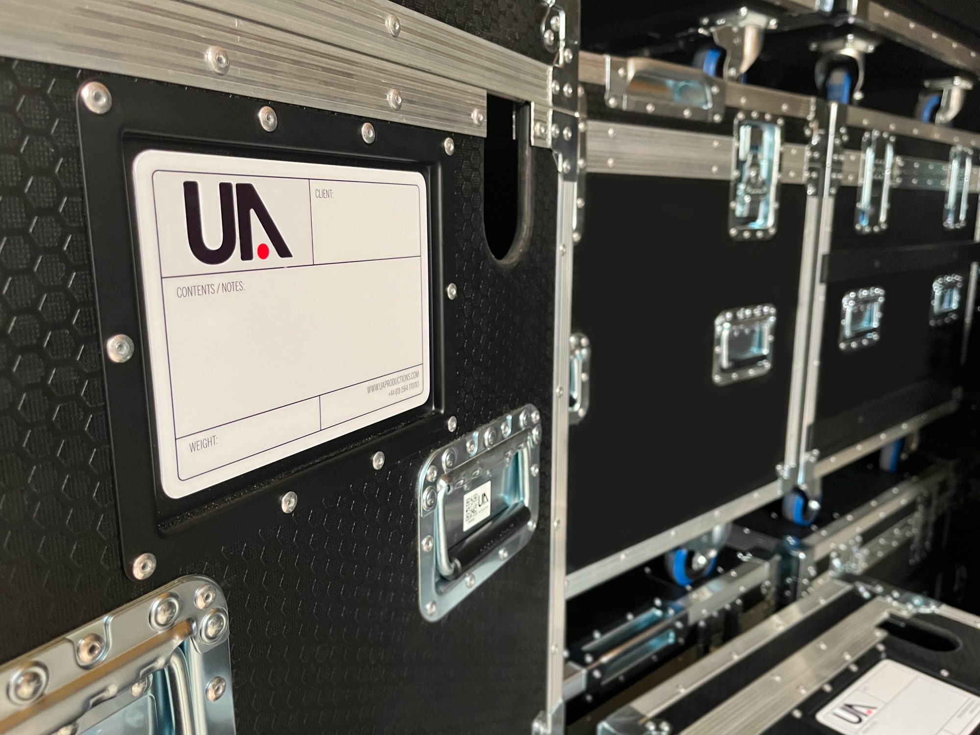 Image of several flight cases built by CNC Cases, displaying tour label with Urban Audio Logo. Made by the people who use them.